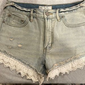 Free People high-rise lace denim shorts.